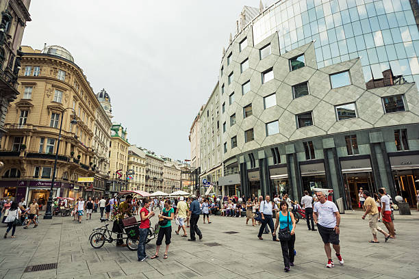 Innere Stadt district of Vienna, Austria Vienna, Austria - August 9, 2013: People meander about the Innere Stadt district of central Vienna at the junction of The Graben, Stephansplatz and Kärntner Straße, one of the most famous and heavily trafficked areas of Vienna.  people shopping in graben street vienna austria stock pictures, royalty-free photos & images
