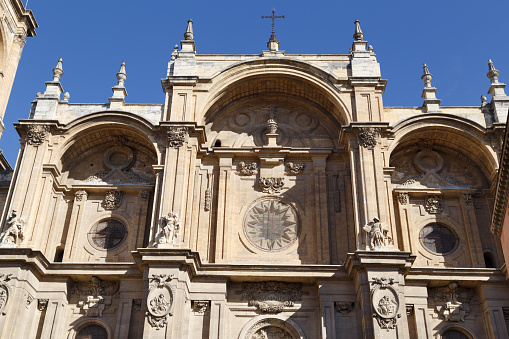 The front facade of the cathedral of Granada in Spain. The architecture is a mixture of Gothic and Renaissance.