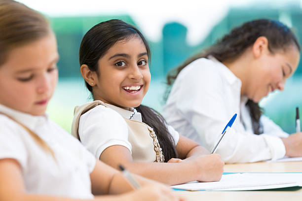 istock Middle eastern girl learning in private school classroom 472095489
