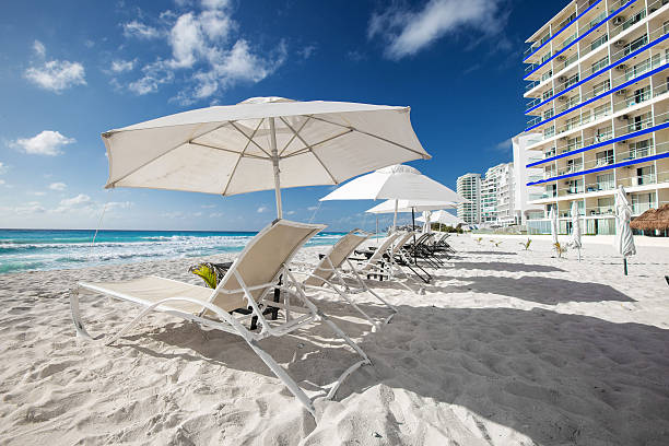 istock Caribbean beach with sun umbrellas and beds 472095774