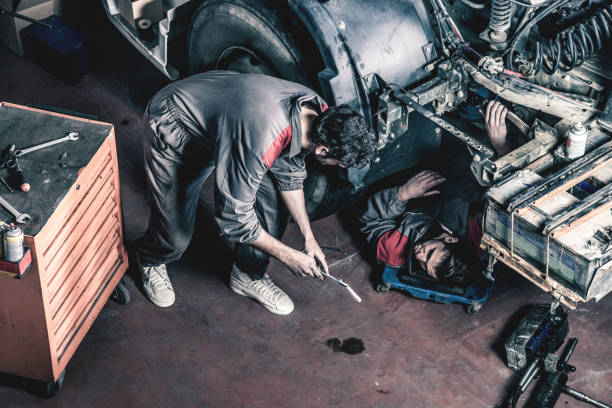 Auto and trucks mechanics Auto and trucks mechanics working on a truck. car mechanic top view stock pictures, royalty-free photos & images