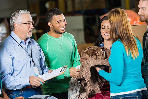 istock Couple donating coats at clothing donation drive 472096493