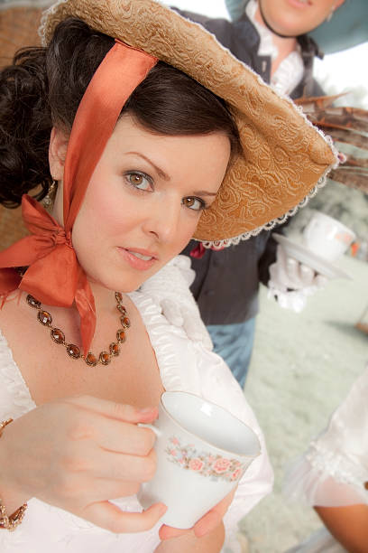 istock Fashion: Victorian style women have afternoon tea. 472096609
