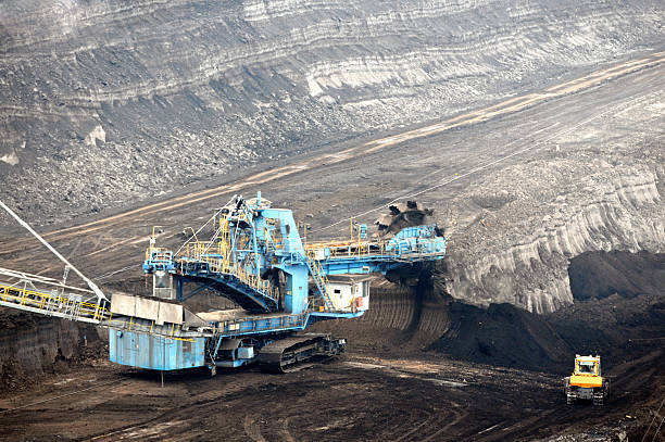 istock Open Strip Coal mine excavator at conveyor belt 472098629