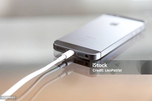 Apple Iphone 5s Backside And Charger Cable Stock Photo - Download Image Now - Apple Computers, Battery, Blurred Motion