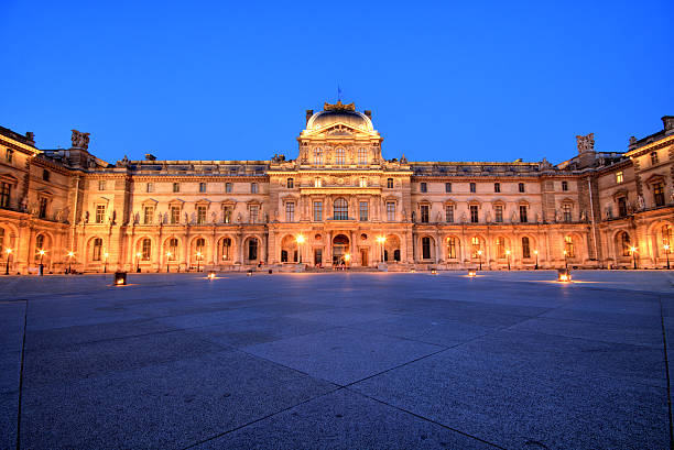 Paris, France - July 9, 2013: Illuminated Louvre museum during sunset in Paris. Completed in 1989 and became one of the landmarks of Paris.