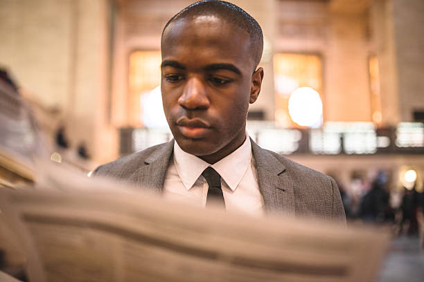 istock business man reading a newspaper inside the station 472099483