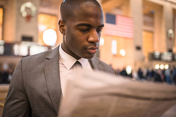 istock business man reading a newspaper inside the station 472099485