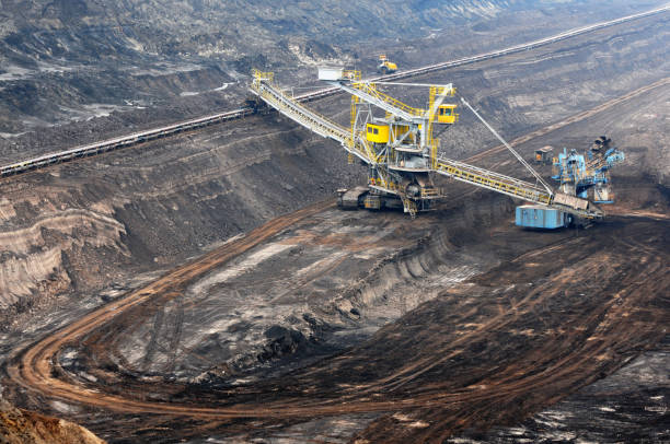 open Strip Coal mine with large wheel excavator at conveyor belt. 