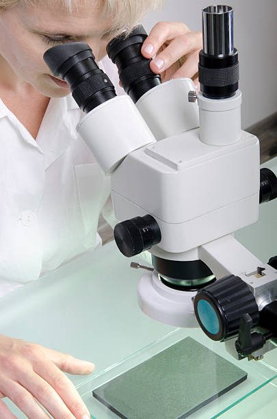 Scientist working with a microscope stock photo