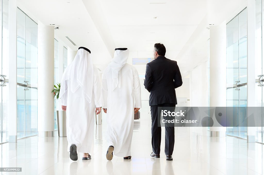 Three arab business men walking, talking, meeting Three arab business men walking, meeting 2015 Stock Photo