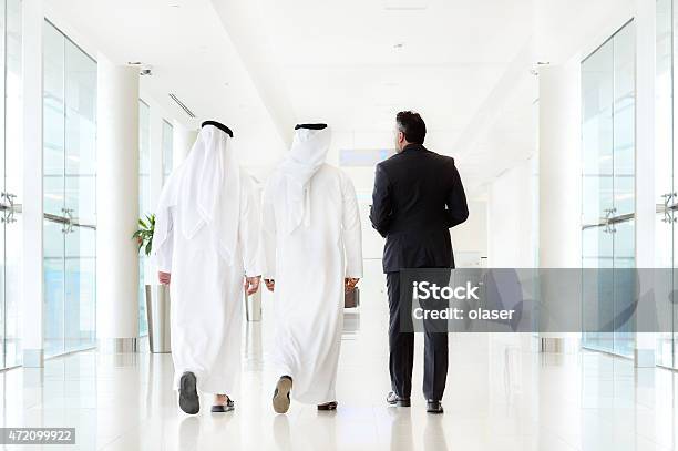 Three Arab Business Men Walking Talking Meeting Stock Photo - Download Image Now - 2015, Adult, Adults Only