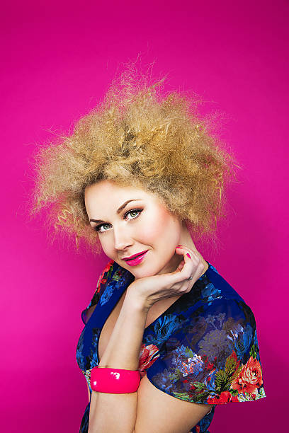 istock Cute woman in blonde afro 472100353