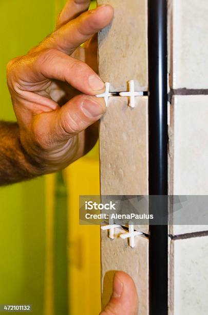 Man Placing Crosses Between Tiles For The Grout Stock Photo - Download Image Now - Grout, 2015, Adult