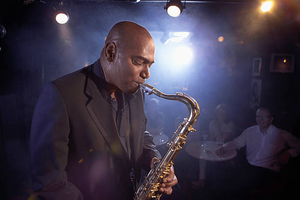 istock Saxophonist Performing In Jazz Club 472101291