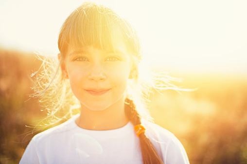 Portrait of a little girl on a field.