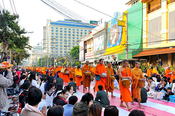 Chiang Mai, Thailand - December 28, 2013 : International Alms Offering to 10,000 monks at Changklan Rd. Chiang Mai Thailand : Buddhist monks began to walk to the public philanthropy by monks walk long distances over 300-400 meters.