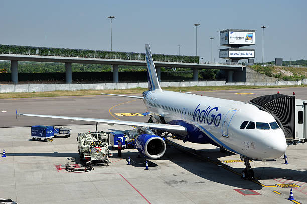 Indigo Airbus A320 Hyderabad, India - Nov 3, 2013: Indigo Airbus A320 connected to the passenger boarding bridge at Rajiv Gandhi International Airport. airbus a320 stock pictures, royalty-free photos & images