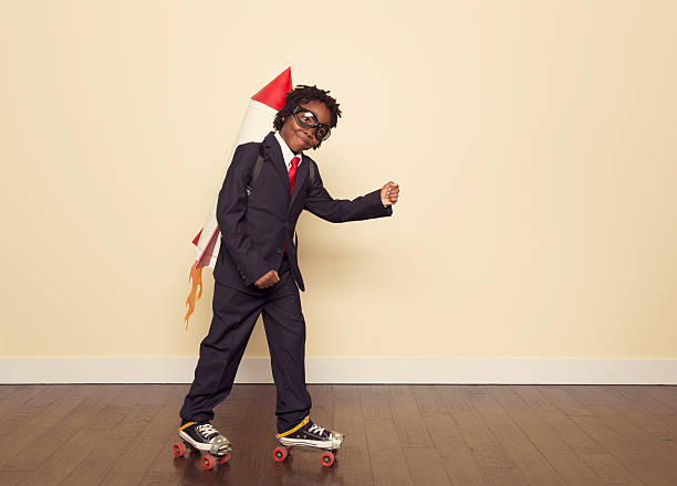 Boy Dressed in Business Suit and Rocket in Studio
