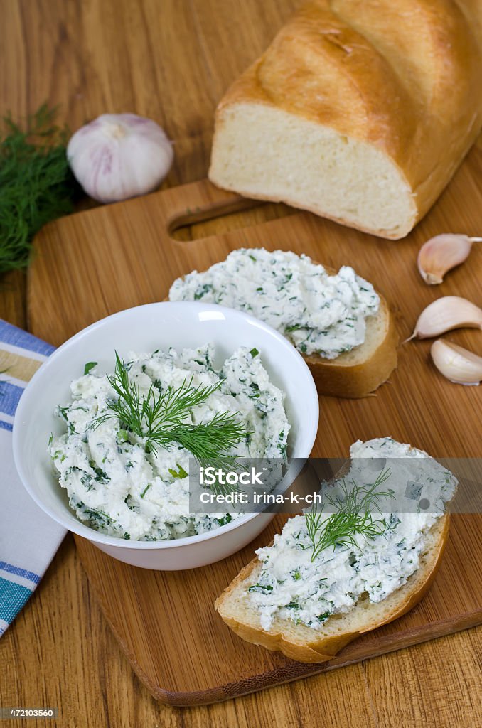 Sandwiches with cheese and parsley. Slices of baguette with cottage cheese parsley, garlic on a cutting board. Curd sandwich in a bowl. 2015 Stock Photo