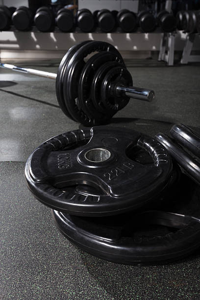 istock metal barbell on dark gray background 472103883