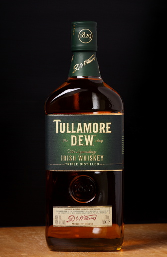 Bracknell, England - January 05, 2014: A single bottle of Tullamore Dew Irish Whiskey in front of a dark background