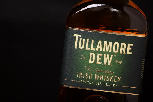 Bracknell, England - January 05, 2014: Close up of a single bottle of Tullamore Dew Irish Whiskey in front of a dark background