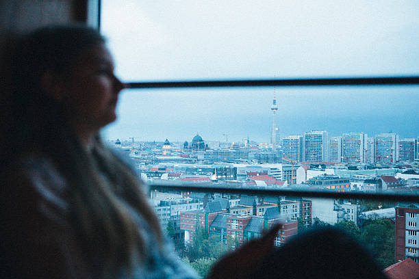 istock Berlin skyline, female silhouette in foreground, twilight 472105514