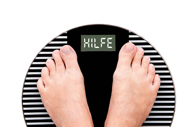 istock Word Help written in German (Hilfe) on a weight scale 472105626