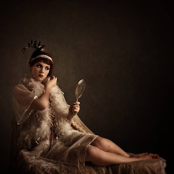 retro beauty looking at herself in a silver hand mirror