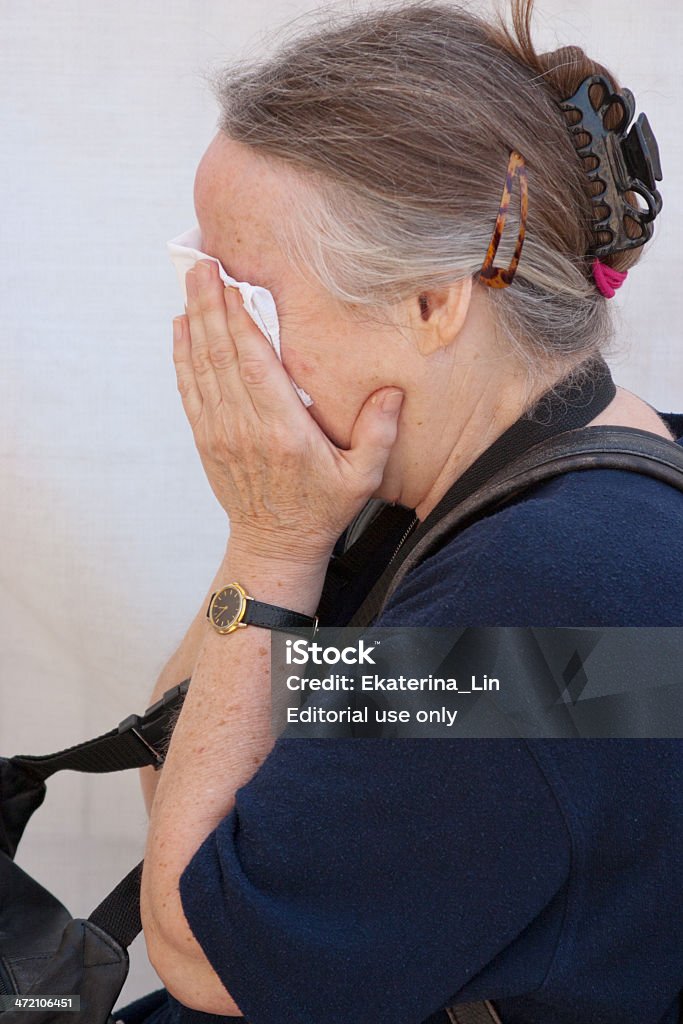 Woman prays at the Wailing Wall. Jerusalem, Israel - March 14, 2006: A woman prays at the Wailing Wall.  Aged woman with gray hair. The Wailing Wall is the holiest place for Jews.   Judaism Stock Photo