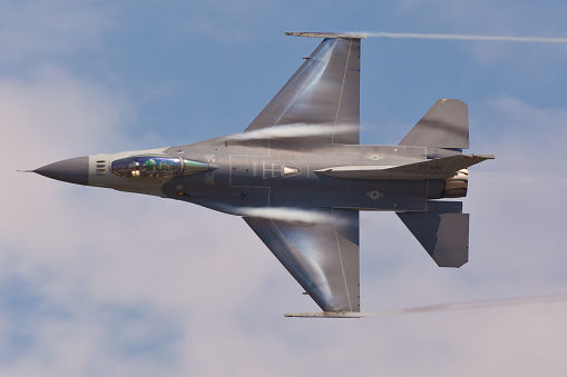Patuxent River, USA - September 3, 2011: F-16 Fighting Falcon performing air show routine on September 3, 2011 during The Naval Air Station Patuxent River Air Expo in Patuxent River, Maryland.  F-16 is the most popular supersonic fighter jet in the world used by 25 different countries. 