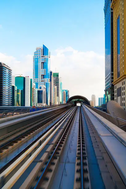 Metrostation in Dubai with high rise along the Sheikh Zayed road. The metrosystem in Dubai is fully automated.    