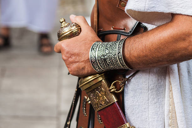 Detail of Centurion Roman soldier carrying a gladius Rome, Italy - September 22, 2013: Detail of a Centurion Roman soldier carrying a gladius. The image is from a costumes parade for the anniversary of the birth of Rome, where people dressed as ancient romans and gladiators walks along the landmarks of the city of Rome. roman centurion stock pictures, royalty-free photos & images