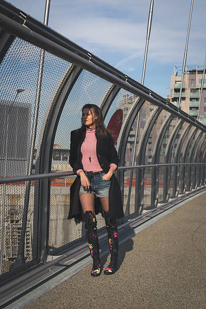 istock Beautiful young brunette posing on a bridge 472108588