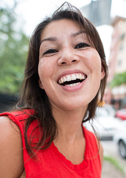 istock young hispanic woman laughing 472108603