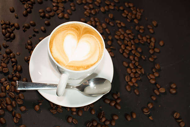 istock cup of coffee and coffee beans over dark background 472108864