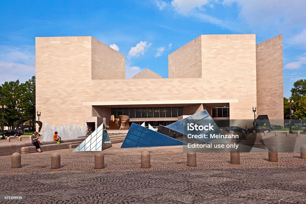 National Gallery of Art in Washington DC Washington, USA - July 14, 2010:  People in background sit on a stone bench. The sit at  the pyramid of the National Gallery of Art pictured in Washington, Maryland (USA). Established in 1937, it is one of the largest in USA. Visit Stock Photo