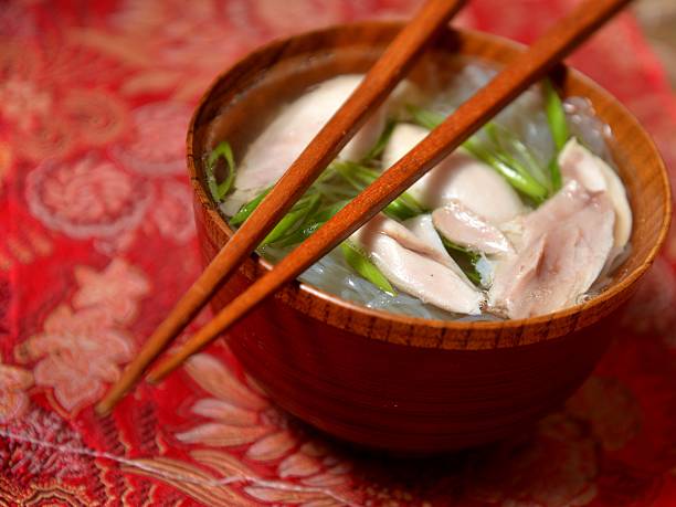 Chinese chicken soup in wooden bowl