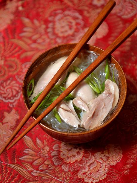 Chinese chicken soup in wooden bowl