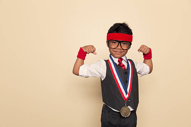 young retro negocios boy flexes músculos y la medalla de oro - ribbon award perfection winning fotografías e imágenes de stock
