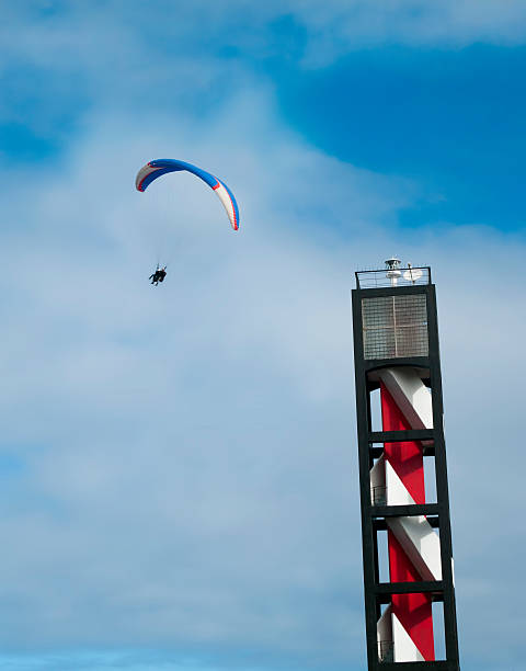 paragliding near lighthouse Puerto de la Cruz, Tenerife, the Canary Islands - 23 November, 2013: Two men paragliding in tandem near the lighthouse in Puerto de la Cruz para ascending stock pictures, royalty-free photos & images