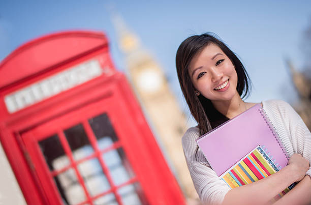 Beautiful Asian woman in her 20s studying English abroad in London and looking very happy