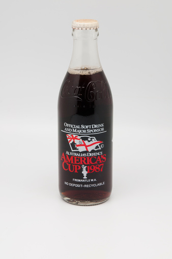 Adelaide, Australia - January 8, 2014: A studio shot of A special edition Glass Coca Cola bottle commemorating the Americas Cup being held in Fremantle Australia in 1987. The first time the cup was held outside of America in over a hundred years.
