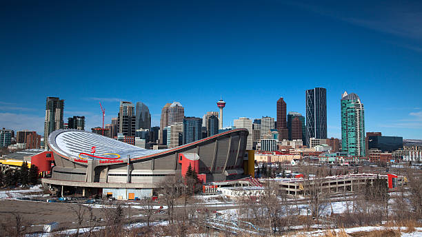 Calgary Skyline Calgary, Canada - February 27, 2013: Calgary's Scotiabank Saddledome sitting prominently infront of the downtown skyline.  The arena, home to the Calgary Flames NHL club is one of the oldest left in the NHL and is rumoured to be replaced in the near future. scotiabank saddledome stock pictures, royalty-free photos & images