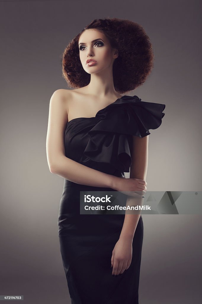 Beautiful woman wearing luxurious black dress Beautiful woman wearing luxurious black dress and with beautiful hair Black Color Stock Photo