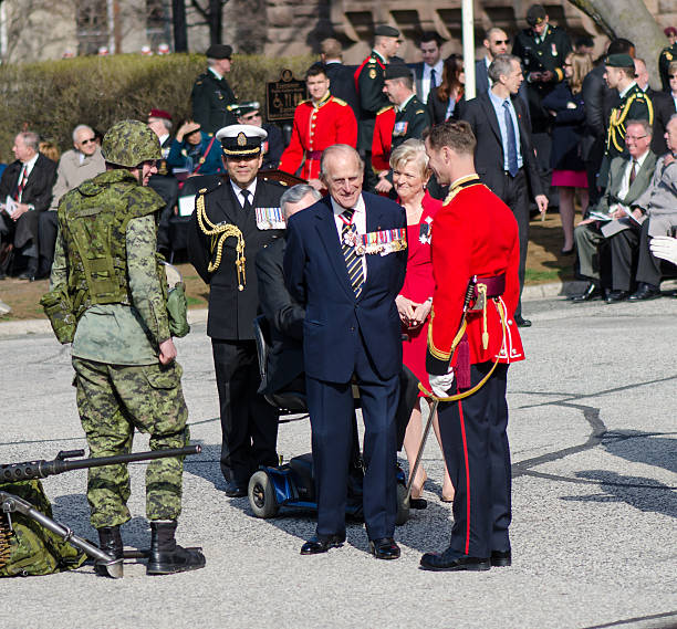 Toronto Bicentennial Commemoration Battle of York Toronto, Canada- April 27,2013:  Prince Philip, the Duke of Edinburgh  visits Canada to present the new Colours to the 3rd Battalion of the Royal Canadian Regiment. The ceremony takes place in front of the Queen's Park Legislative Assembly of Ontario. His Royal Highness is the Colonel-in-Chief of the Royal Canadian Regiment since December 1953 british royalty photos stock pictures, royalty-free photos & images