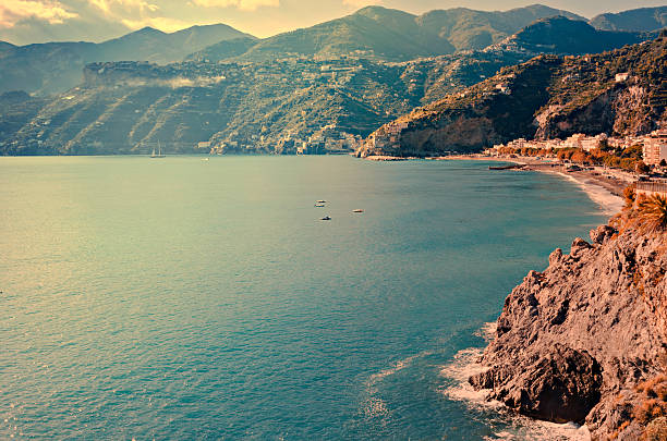Sea waves breaking on the rocky coast. Amalfi, Italy.