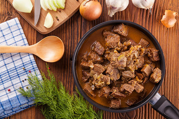 istock Beef stew - wooden background 472115642