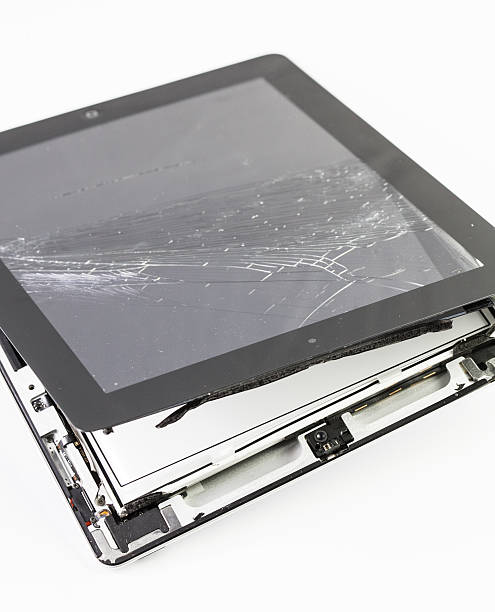 Destroied Apple Ipad Rome, Italy - January 11, 2014: An iPad felt on the road and was destroyed by a passing car, becoming completely useless. broken digital tablet note pad cracked stock pictures, royalty-free photos & images